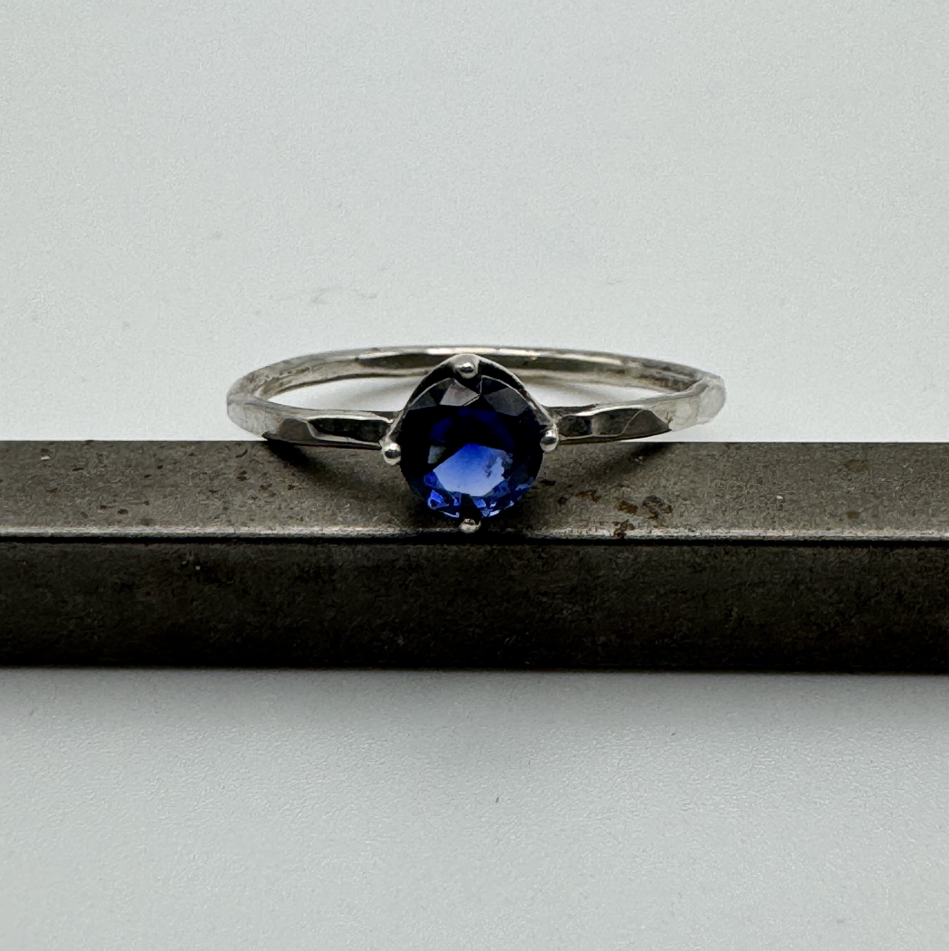 Sapphire ring with hammer textured band