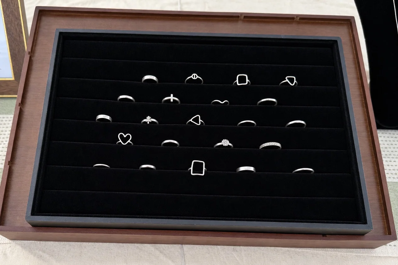Sterling silver heart, triangle, square, and textured band rings in a black display tray