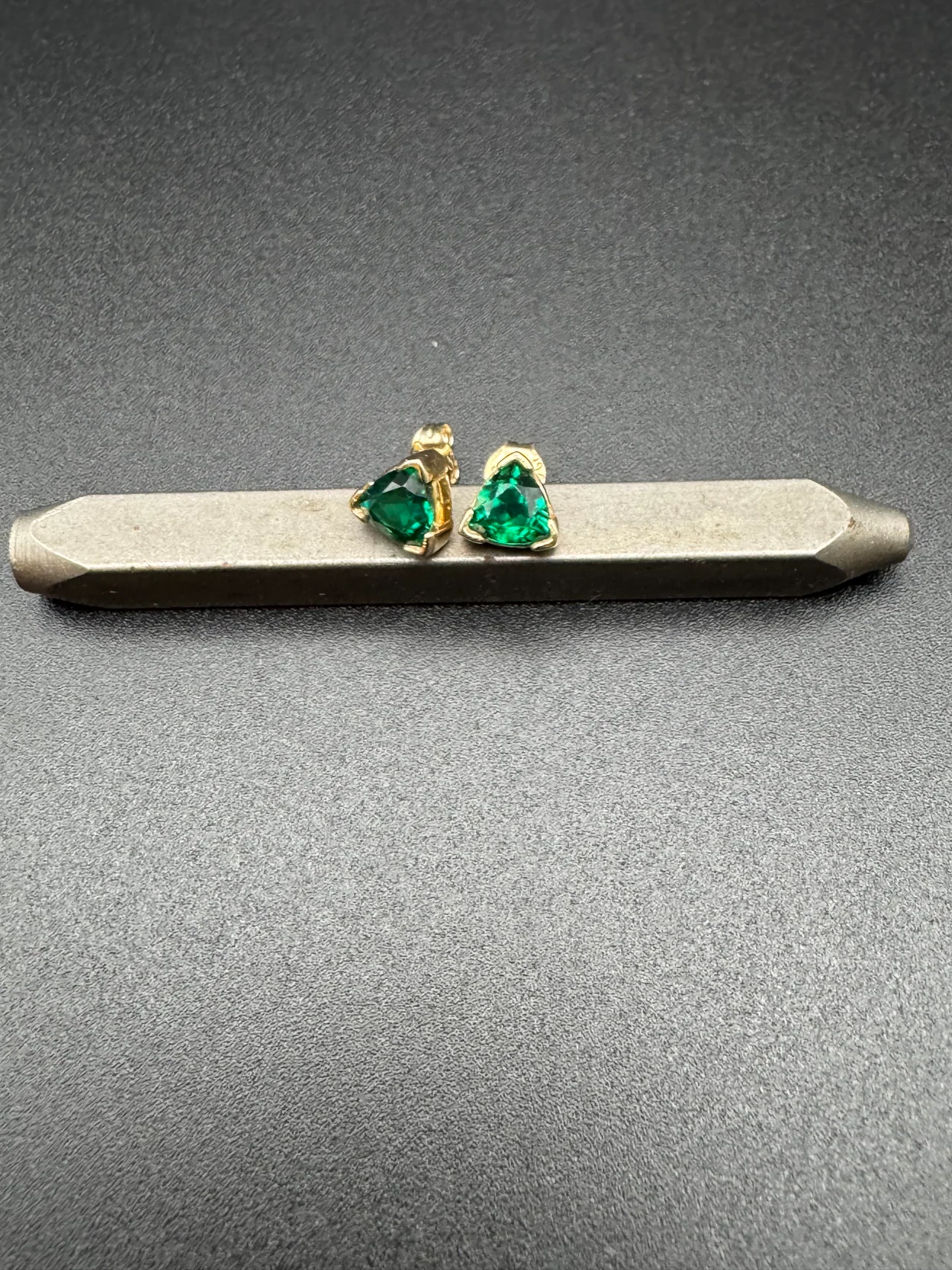 Trillion cut emerald stud earrings in 14k gold